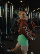 Load image into Gallery viewer, Side view of brown Boyfriend Hoodie with silver rhinestone sleeve lettering
